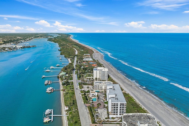 drone / aerial view featuring a water view and a view of the beach