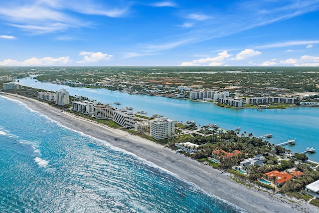 drone / aerial view featuring a water view and a view of the beach