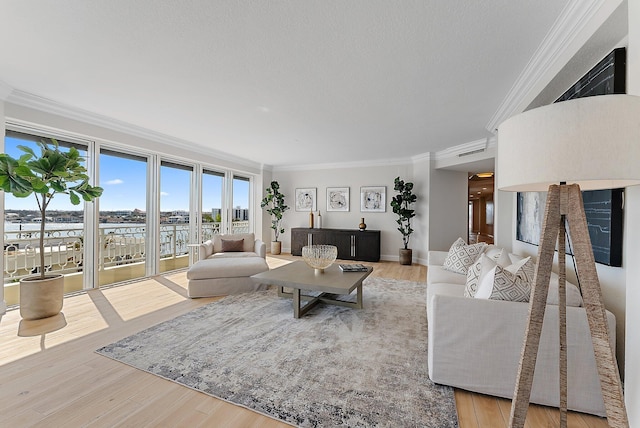 living room featuring a water view, crown molding, a textured ceiling, and hardwood / wood-style flooring