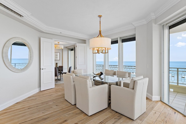 living room with crown molding, light hardwood / wood-style floors, and a water view