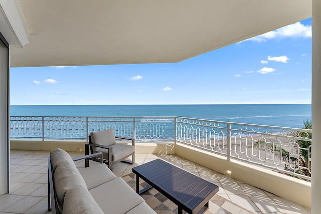 balcony featuring a water view, an outdoor living space, and a beach view