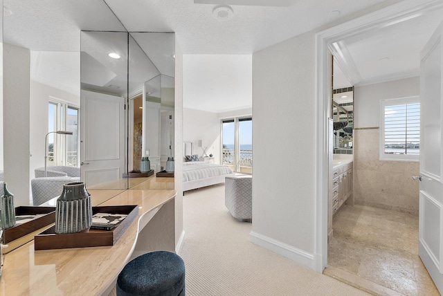 bathroom with vanity, a wealth of natural light, and a textured ceiling