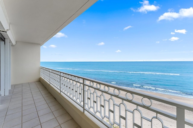 balcony featuring a water view and a view of the beach