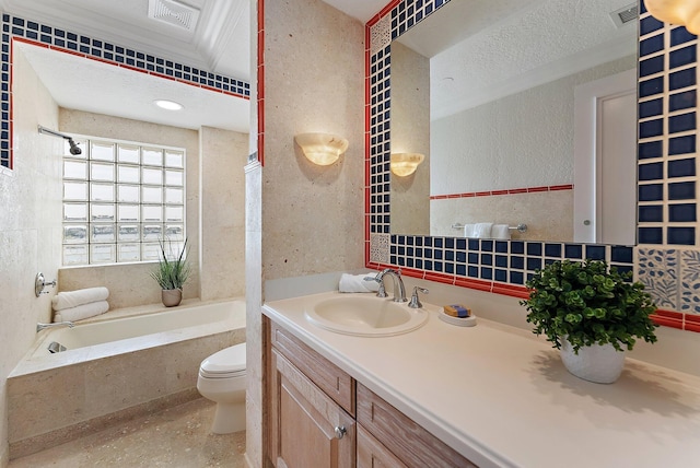 bathroom with vanity, a washtub, a textured ceiling, and toilet