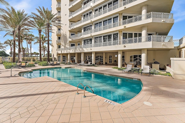 view of swimming pool with a patio