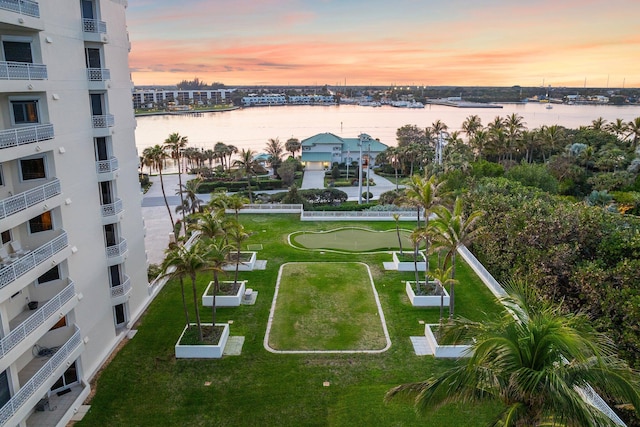 aerial view at dusk featuring a water view