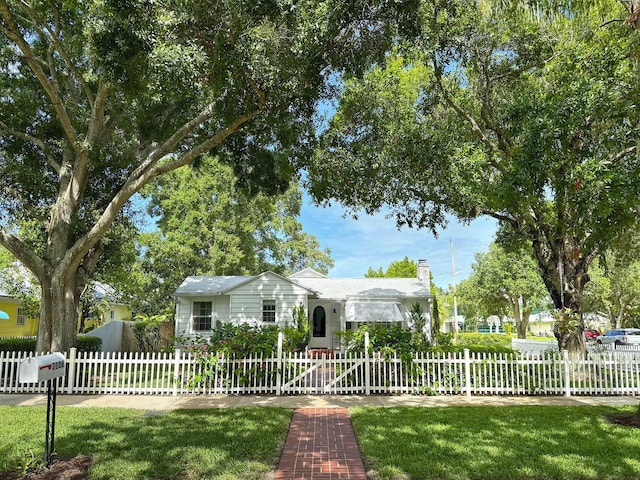 single story home with a fenced front yard and a chimney