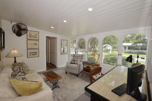 sunroom featuring lofted ceiling, wood ceiling, and a healthy amount of sunlight