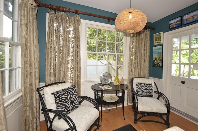 sitting room featuring plenty of natural light and wood finished floors