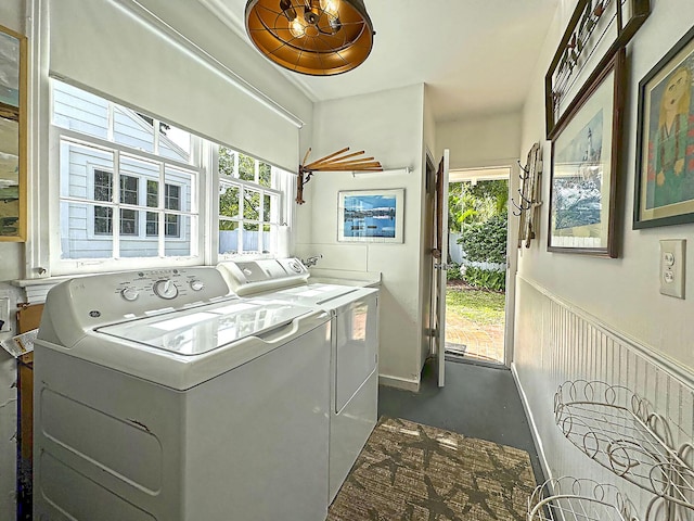 laundry room with a wainscoted wall, laundry area, and washing machine and clothes dryer