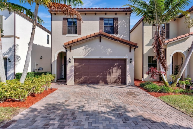 mediterranean / spanish-style house featuring a garage