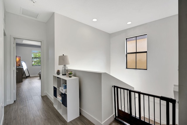 corridor with dark hardwood / wood-style flooring