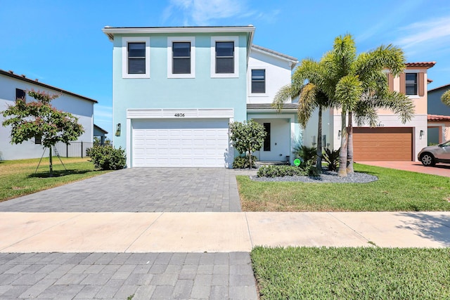 view of front of house with a garage and a front lawn