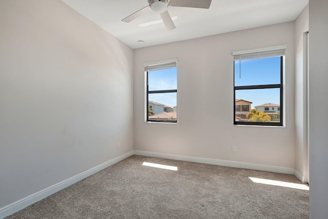 unfurnished room with ceiling fan and carpet flooring