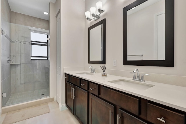 bathroom with tile patterned floors, vanity, and a shower with shower door