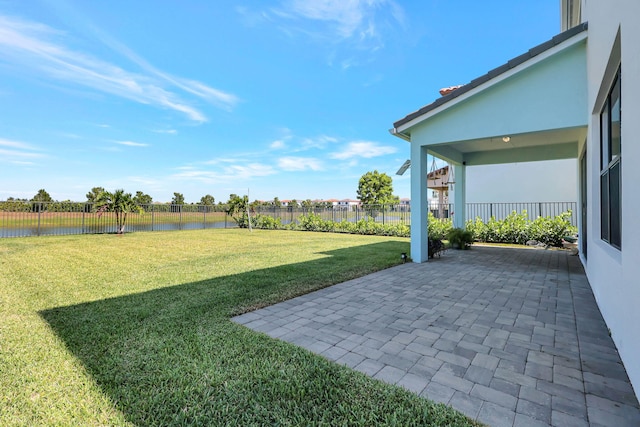 view of yard with a patio and a water view