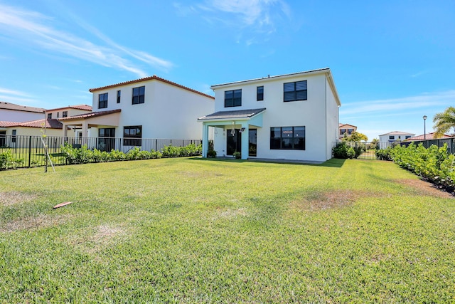 rear view of property featuring a yard