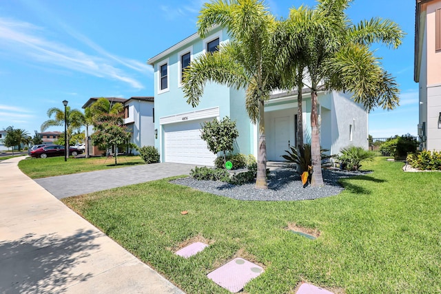 view of front of home with a garage and a front yard