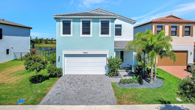 view of front of home with a garage and a front lawn