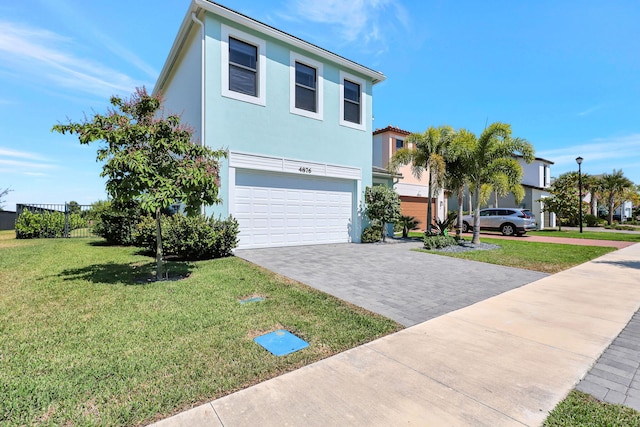 view of front of property featuring a garage and a front yard