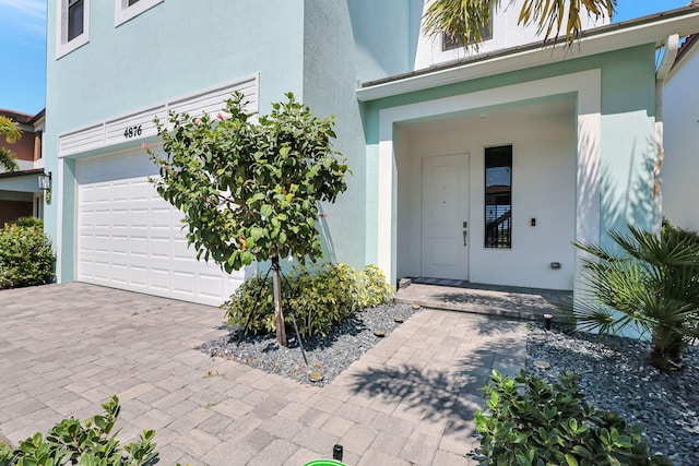 view of exterior entry with a garage