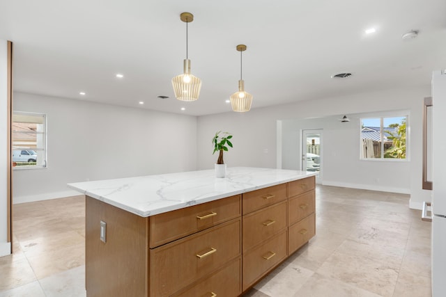 4430 SE Bayshore Ter, Stuart, FL 34997 - kitchen featuring plenty of natural light, decorative light fixtures, a kitchen island, light stone countertops, and recessed lighting