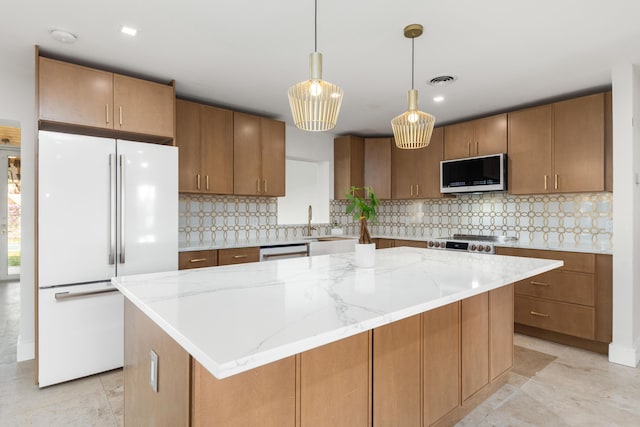 kitchen with light stone counters, a kitchen island, freestanding refrigerator, dishwasher, and tasteful backsplash