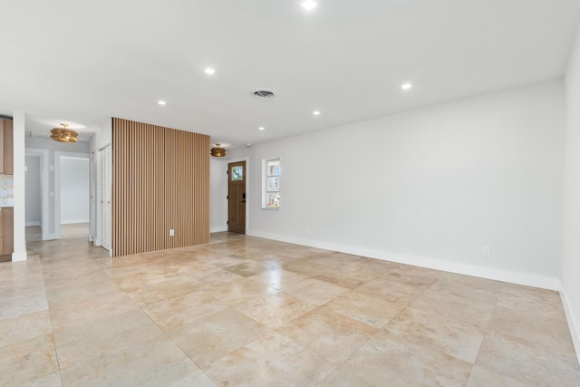 spare room featuring recessed lighting, visible vents, and baseboards