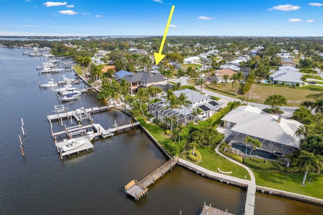 birds eye view of property with a water view and a residential view