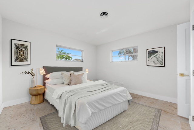 bedroom featuring baseboards and visible vents