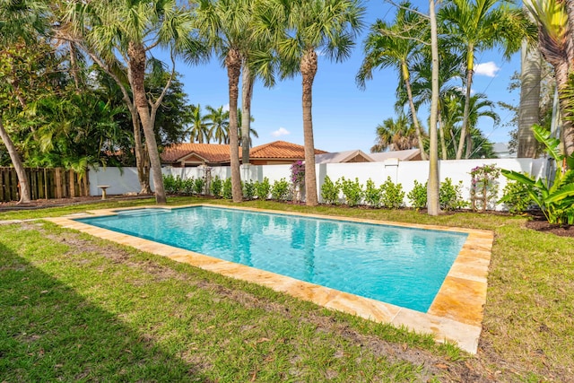 view of pool with a lawn, a fenced backyard, and a fenced in pool