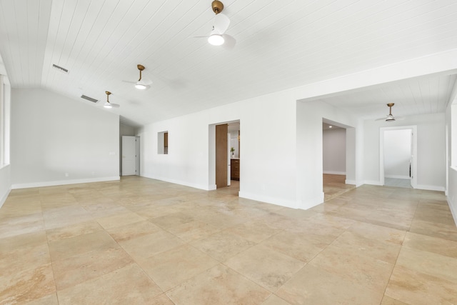 spare room with vaulted ceiling, visible vents, a ceiling fan, and baseboards