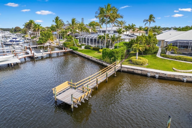 dock area featuring a lawn and a water view