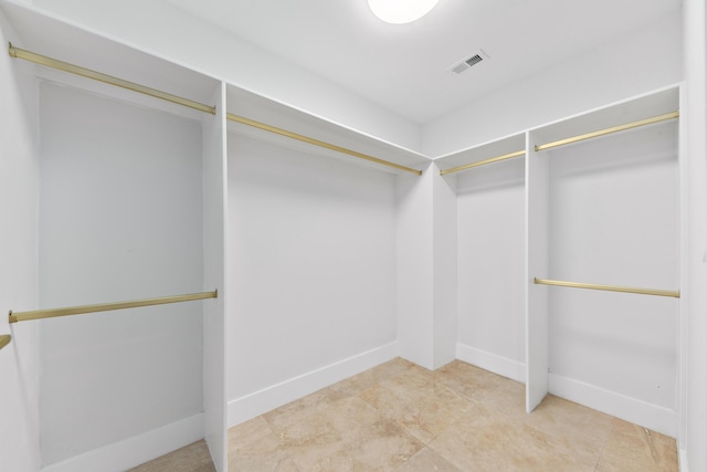 spacious closet featuring visible vents