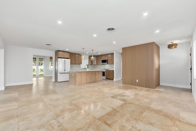 kitchen featuring visible vents, white appliances, and open floor plan