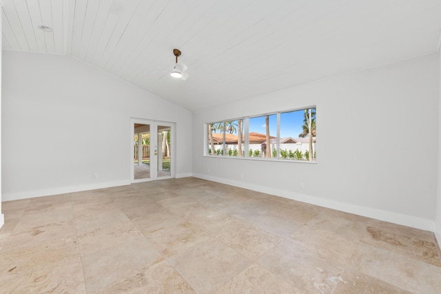 empty room featuring baseboards, french doors, and high vaulted ceiling