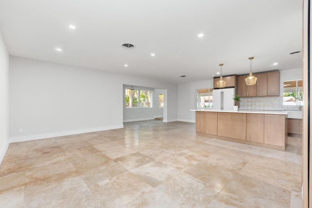 4430 SE Bayshore Ter, Stuart, FL 34997 - kitchen with freestanding refrigerator, light countertops, recessed lighting, decorative backsplash, and open floor plan