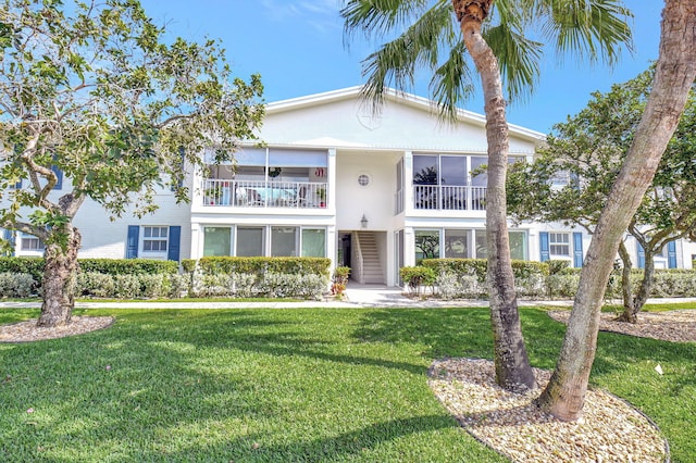 view of front of house with a front lawn and stucco siding