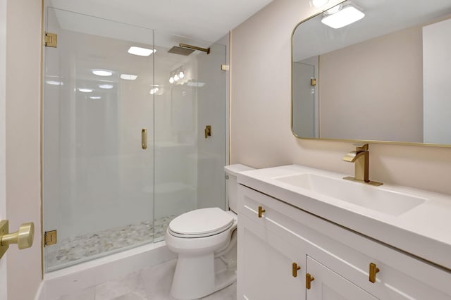 full bathroom with vanity, a shower stall, and toilet