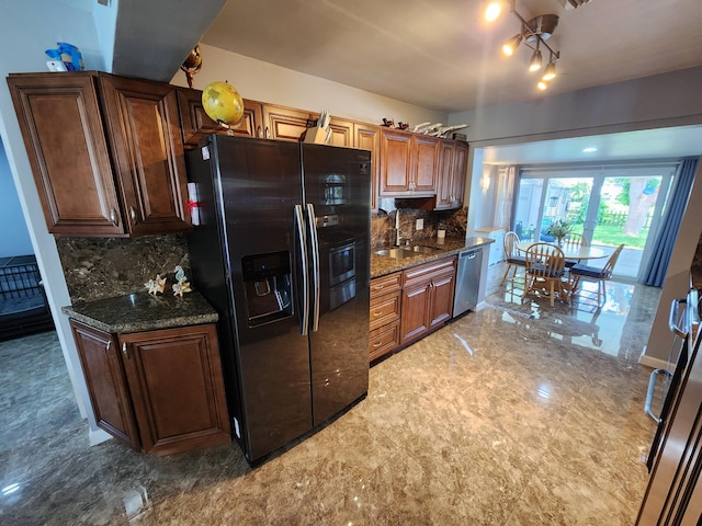 kitchen featuring tasteful backsplash, sink, stainless steel dishwasher, and black fridge