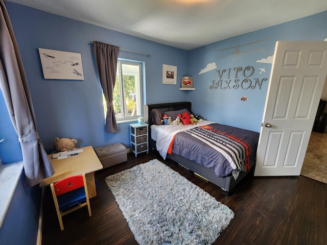 bedroom with hardwood / wood-style floors