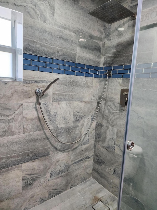 bathroom with a tile shower