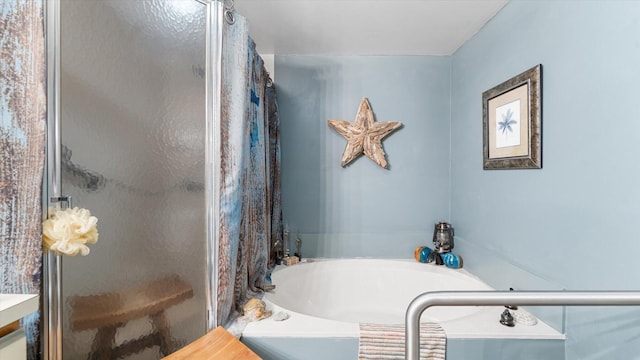 bathroom featuring shower with separate bathtub