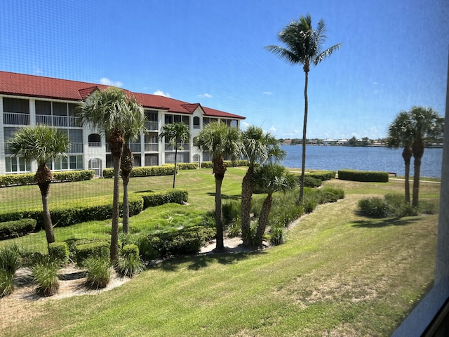 view of home's community featuring a yard and a water view