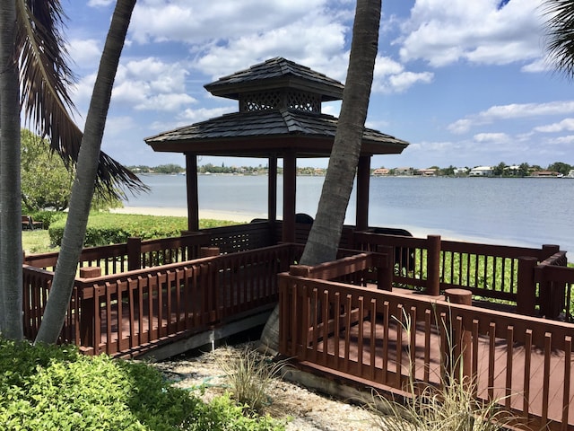 dock area featuring a gazebo and a deck with water view