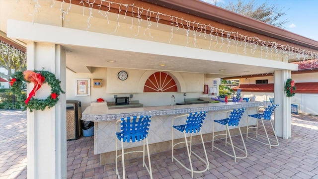 view of patio with an outdoor wet bar