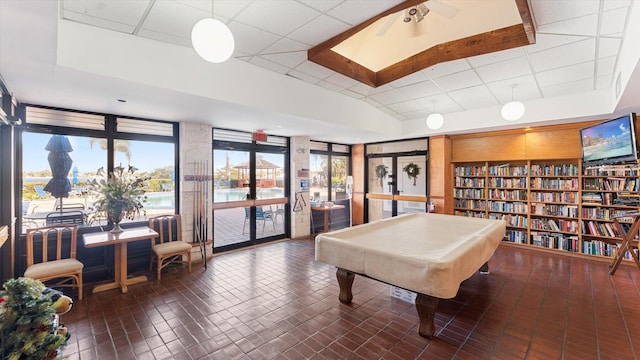 recreation room with a paneled ceiling