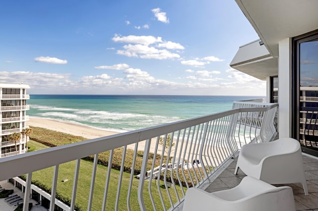 balcony with a beach view and a water view