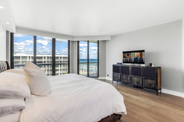 bedroom featuring access to outside and light hardwood / wood-style flooring