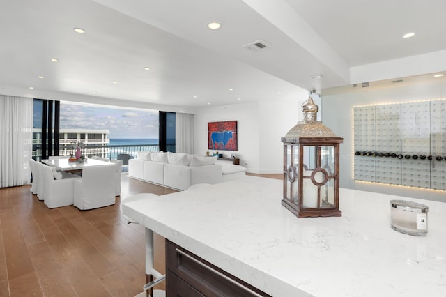 kitchen with hardwood / wood-style flooring and a water view